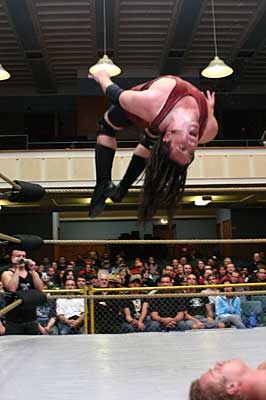 IPW Star Jon E. King in flight while delivering a moonsault